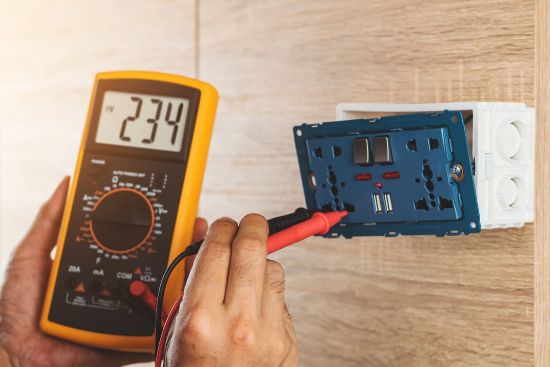 Using a digital meter to measure the voltage.